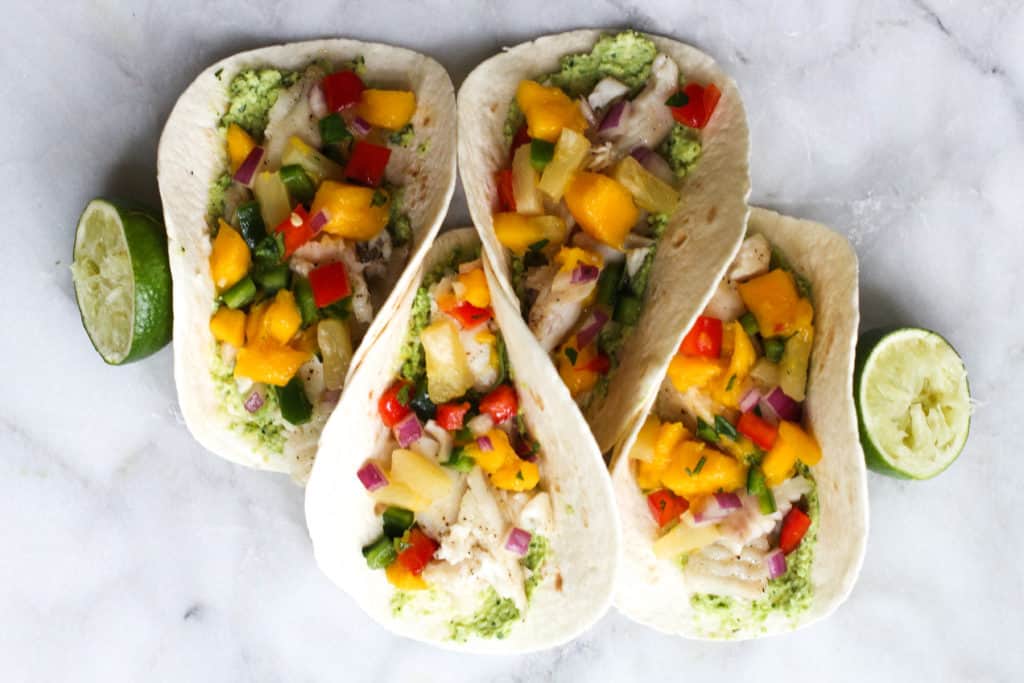 These Fish Tacos with Pineapple Mango Salsa are an easy and flavorful dish for the summer!