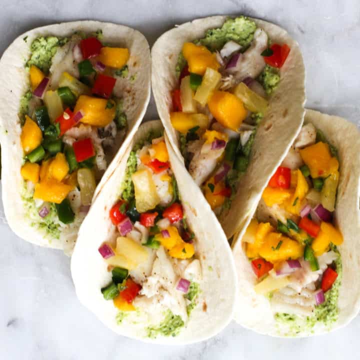 These Fish Tacos with Pineapple Mango Salsa are an easy and flavorful dish for the summer!