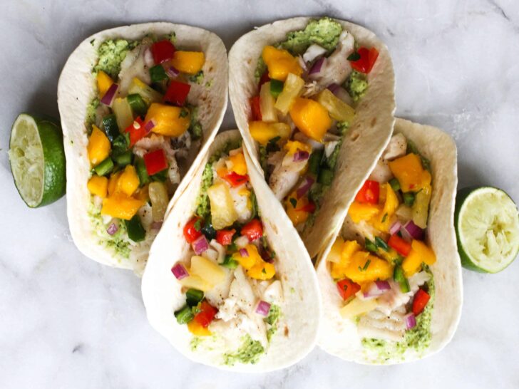 These Fish Tacos with Pineapple Mango Salsa are an easy and flavorful dish for the summer!