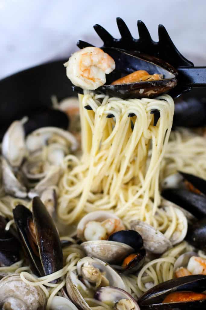 This Easy Seafood Pasta with White Wine Butter Sauce is quick enough for a week night, but still great to impress your guests!