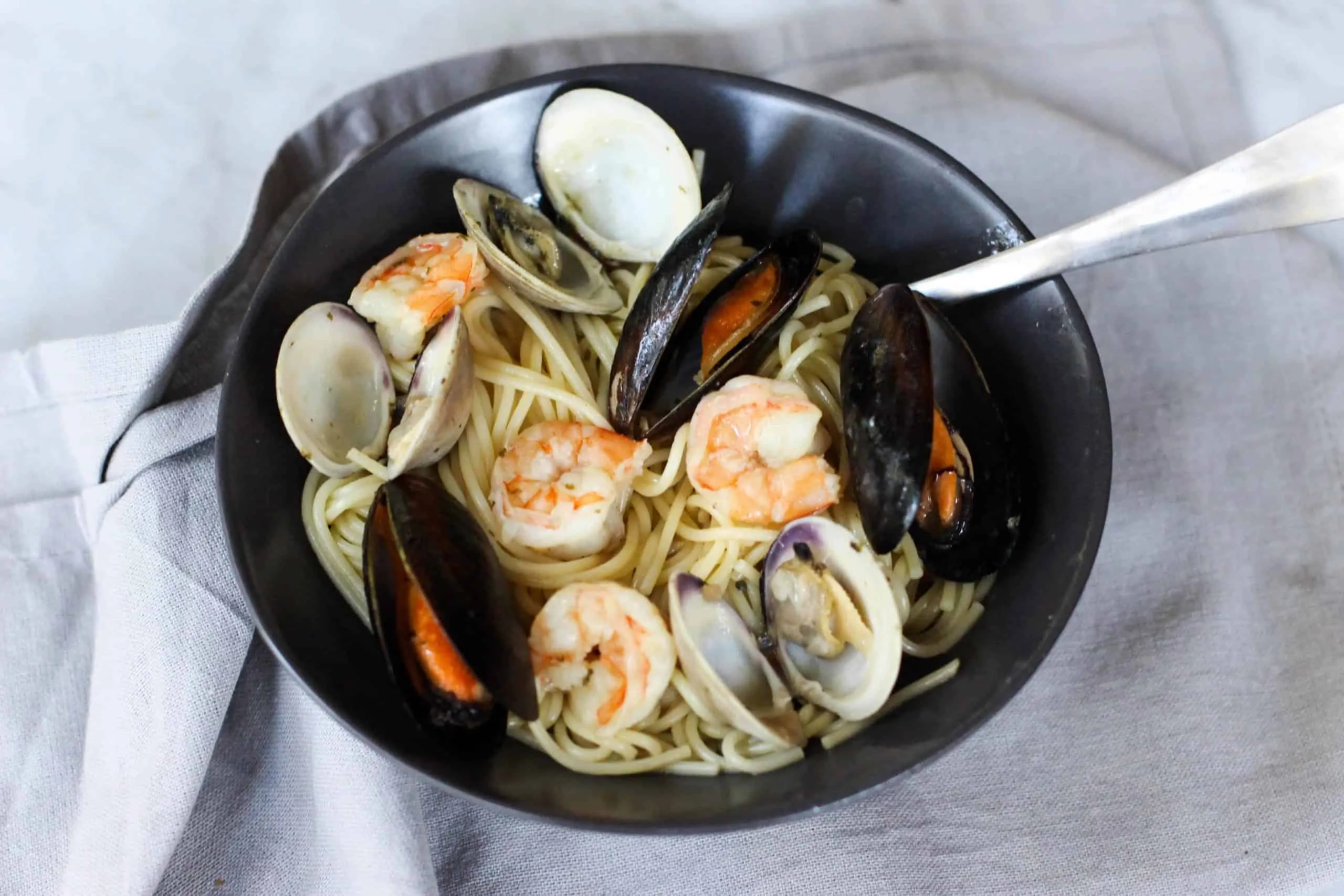 This Easy Seafood Pasta with White Wine Butter Sauce is quick enough for a week night, but still great to impress your guests!