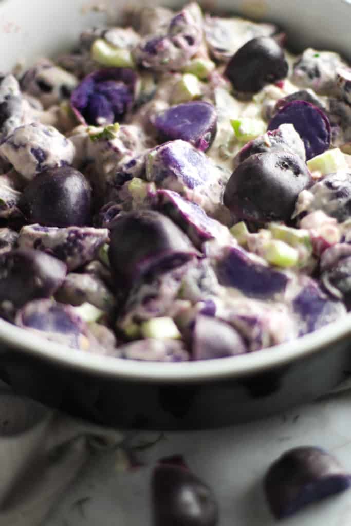 This Purple Potato Salad is an easy dish to throw together, bring to a tailgate, and show your team spirit!