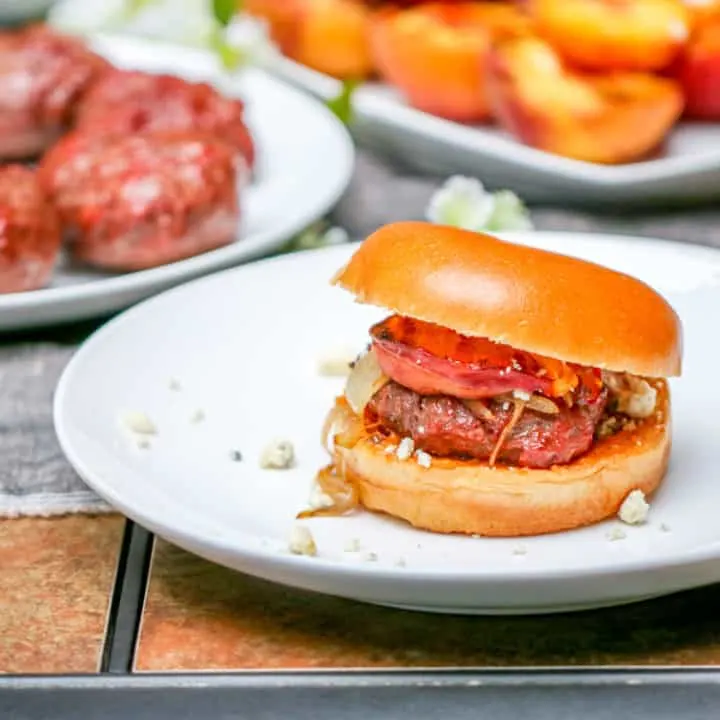 These Aussie Grass Fed Beef Burgers with Grilled Peaches and Chipotle Onion Jam are layered with bold flavors and perfect for the adventurous eater!