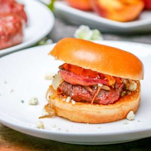 These Aussie Grass Fed Beef Burgers with Grilled Peaches and Chipotle Onion Jam are layered with bold flavors and perfect for the adventurous eater!