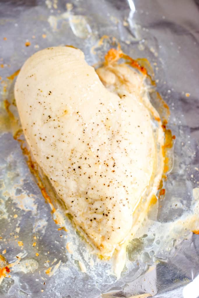 one cooked chicken breast on aluminum foil after being cooked