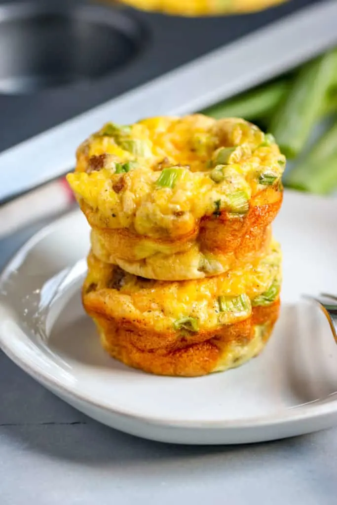 a close up image of two sausage egg muffins sitting on top of each other 