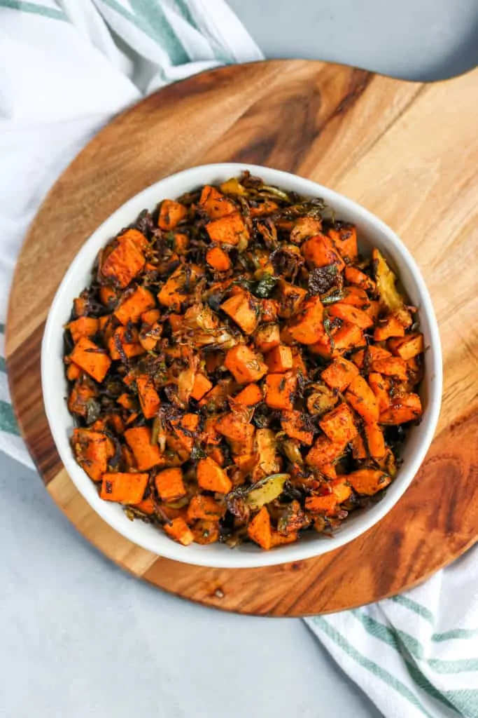 an overhead shot of a bowl of roasted shaved brussels sprouts and sweet potatoes