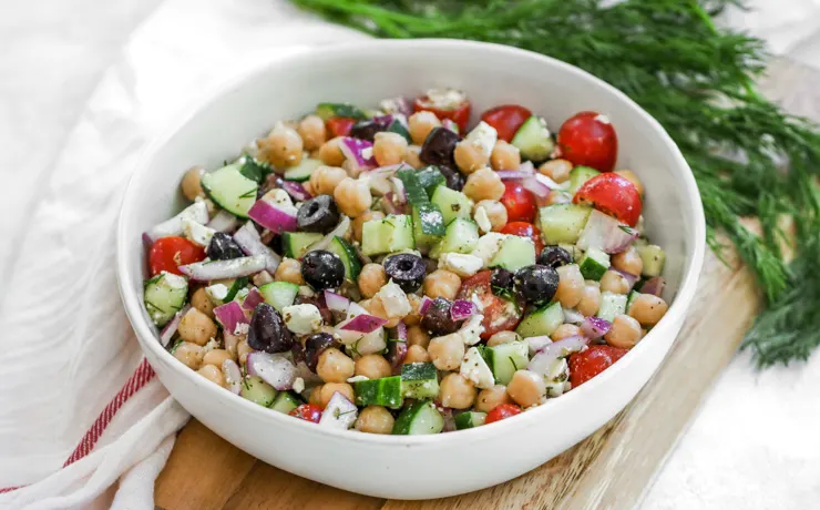 a close up shot of Mediterranean Chickpea Salad in a white bowl