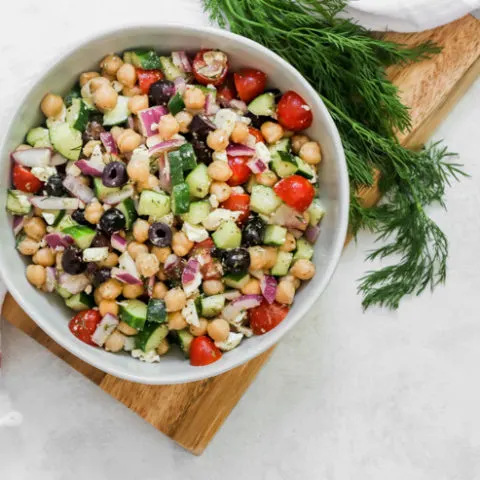 an overhead shot of Mediterranean Chickpea Salad next to a sprig of dill