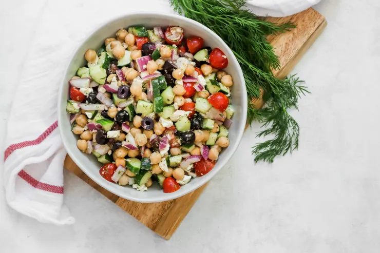 an overhead shot of Mediterranean Chickpea Salad next to a sprig of dill