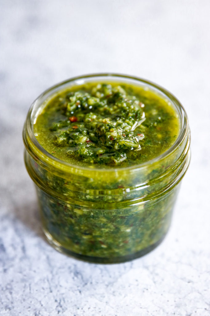 a closeup of almond pesto in a small mason jar