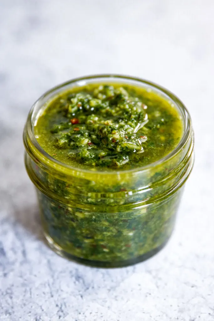 a closeup of almond pesto in a small mason jar