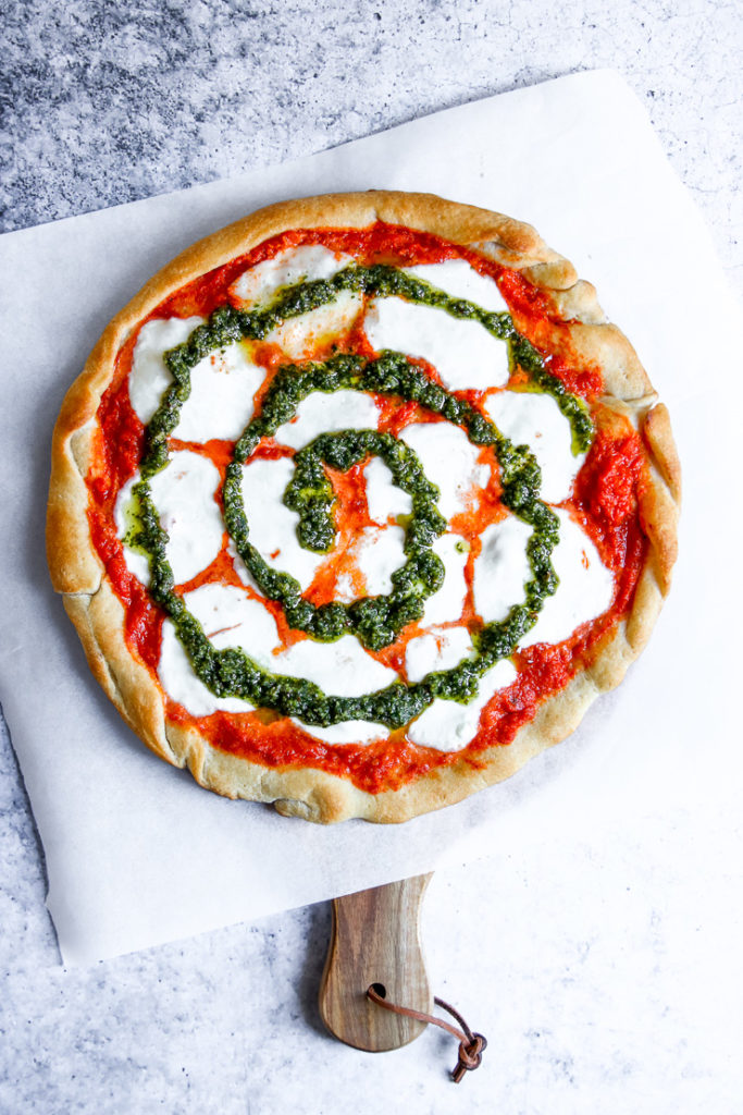 a swirl of pesto on tie dye pizza