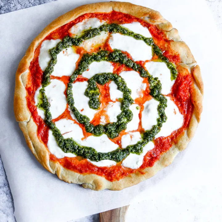 a swirl of pesto on tie dye pizza