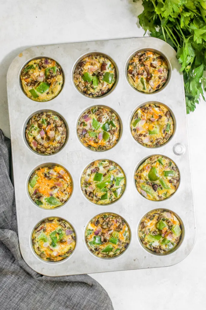 a tray of 12 veggie egg muffins in a muffin tin