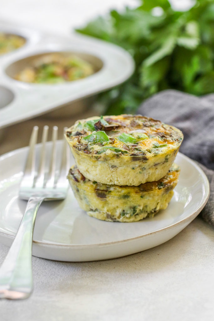 a close up of two veggie egg muffins