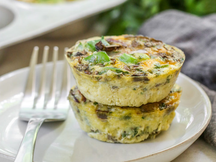 a close up of two veggie egg muffins