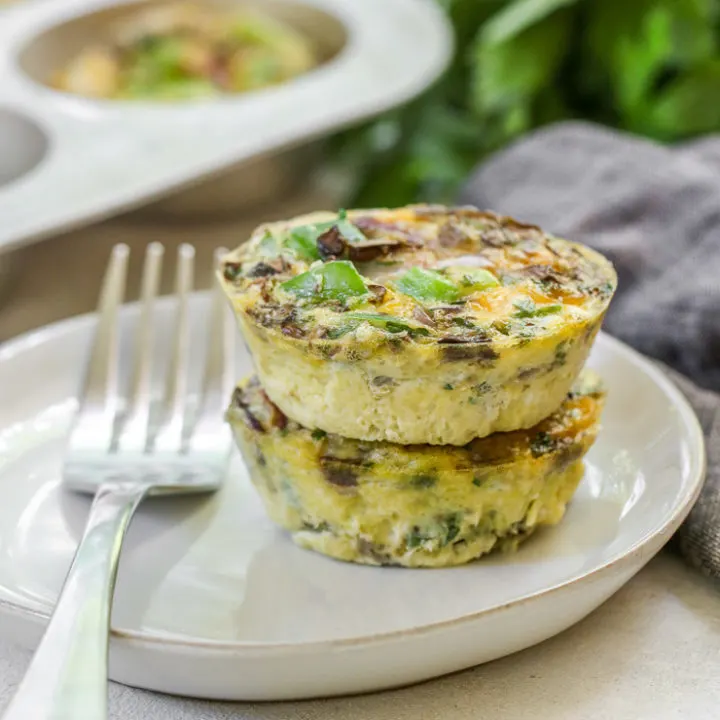 a close up of two veggie egg muffins