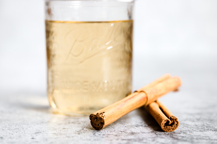 an up close image of cinnamon sticks with the mason jar behind it