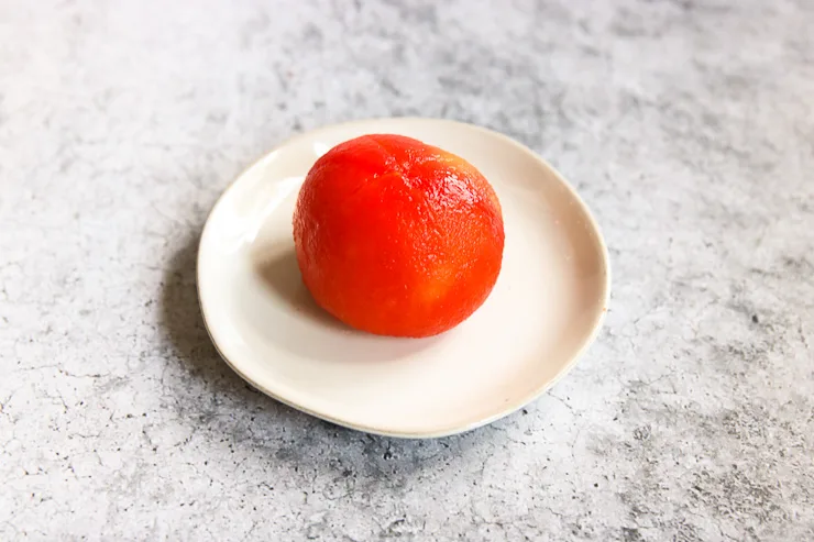 a peeled tomato on a plate