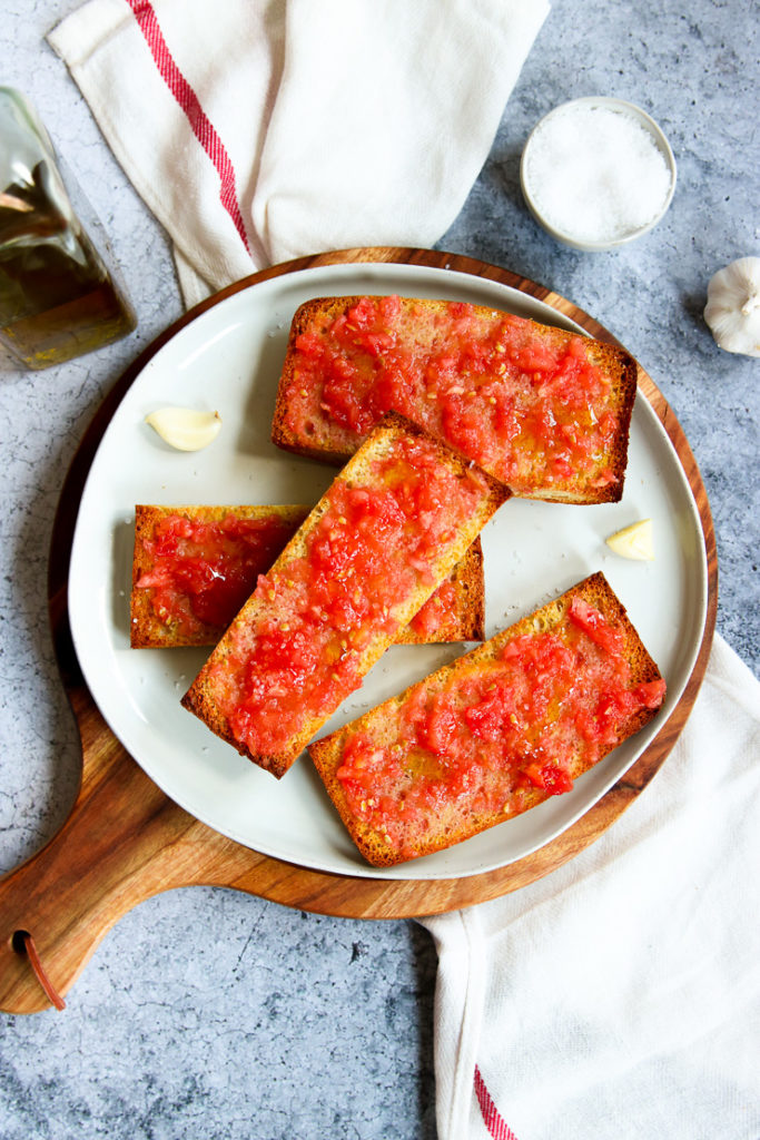 a plate of sliced pan con tomate