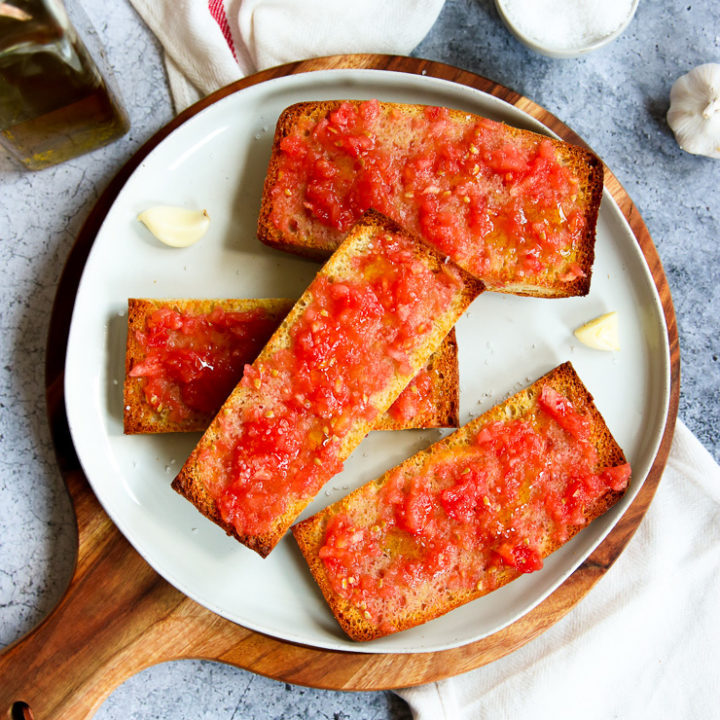 a plate of sliced pan con tomate