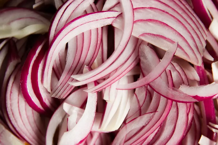 close up of thinly sliced red onions