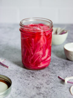 a mason jar of pickled red onions