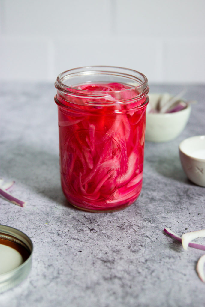 a mason jar of pickled red onions