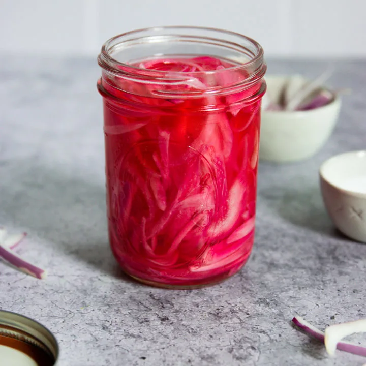 a mason jar of pickled red onions