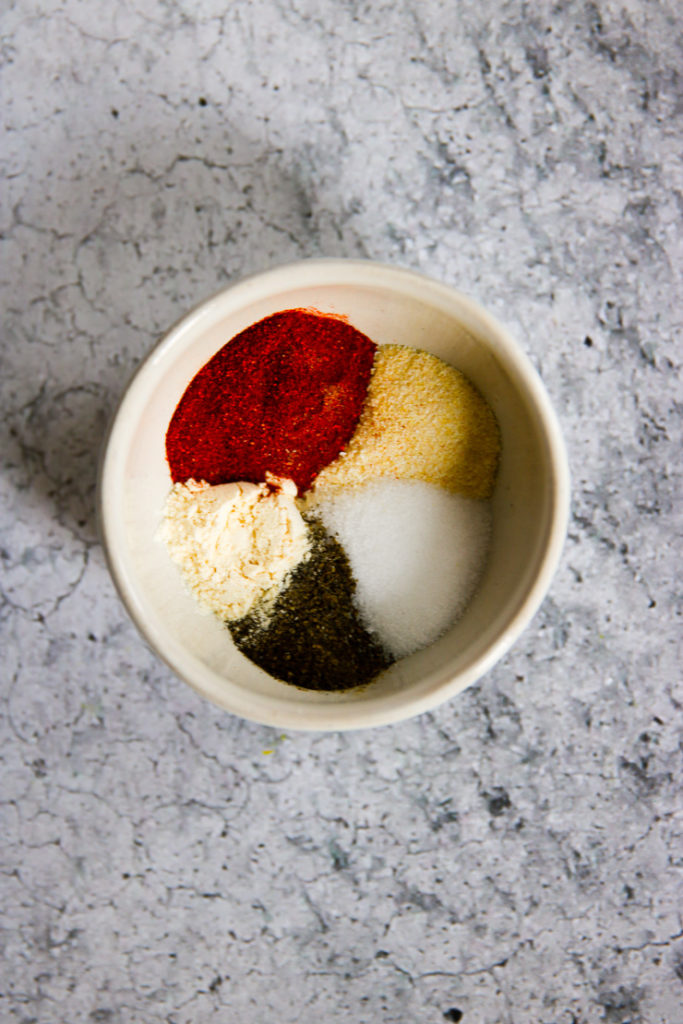 An overhead shot of a seasoning blend in a white bowl