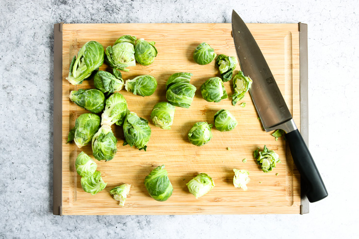 cutting board showing the ends of the brussels sprouts cut off