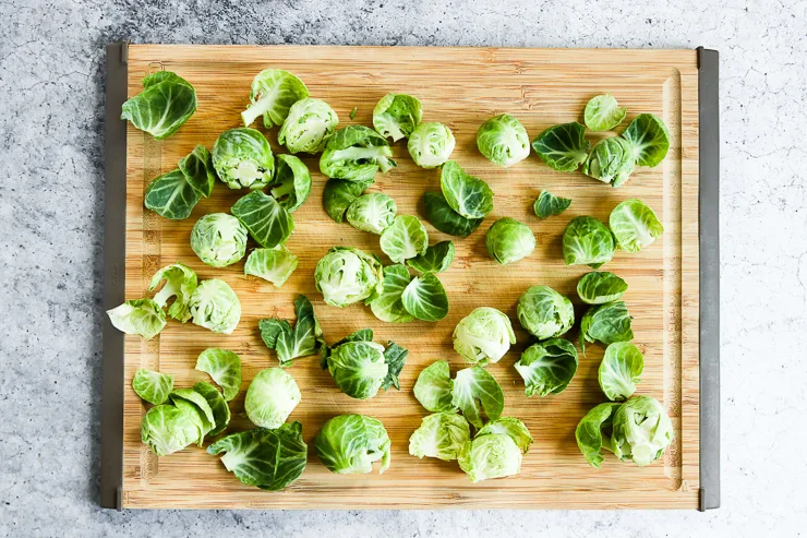 peeled leaves off of the brussels sprouts on a cutting board