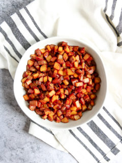 An overhead shot of a white bowl filled with Skillet Breakfast Potatoes