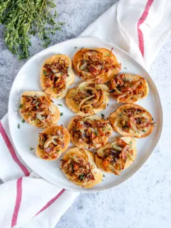 a plate of bacon caramelized onion crostini