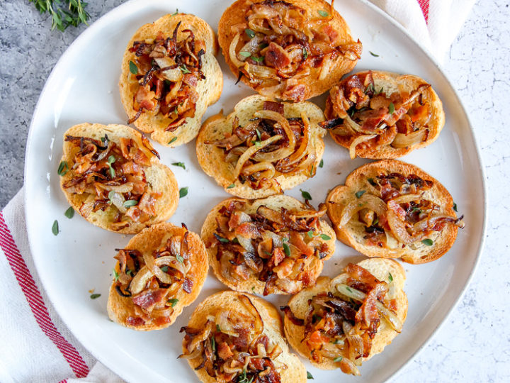 a plate of bacon caramelized onion crostini