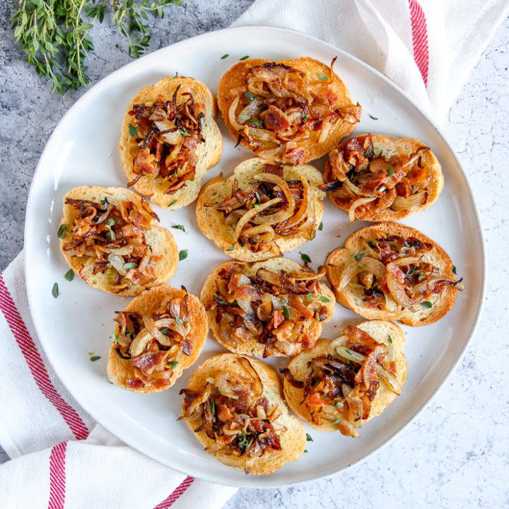 a plate of bacon caramelized onion crostini