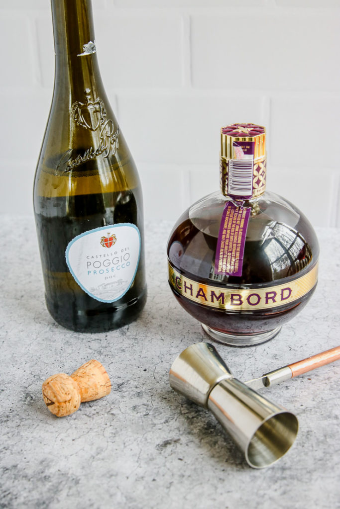 prosecco bottle, cork, chambord bottle, and jigger