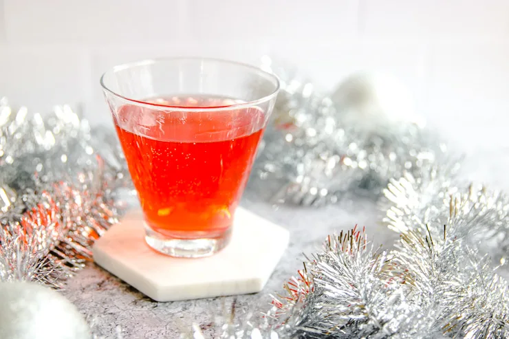 a stemless martini glass filled with cranberry ginger ale punch