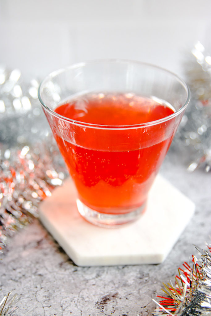 a close up a stemless martini glass with cranberry ginger ale punch