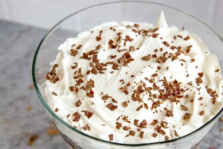 whipped cream and chocolate shavings in a glass serving bowl