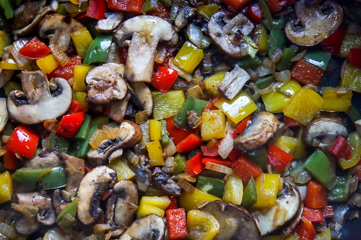 a close up image of mushrooms, onions, and peppers