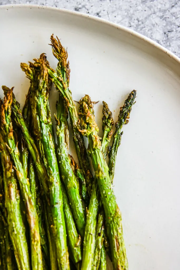 a close up of the roasted tips of the air fried asparagus stalks