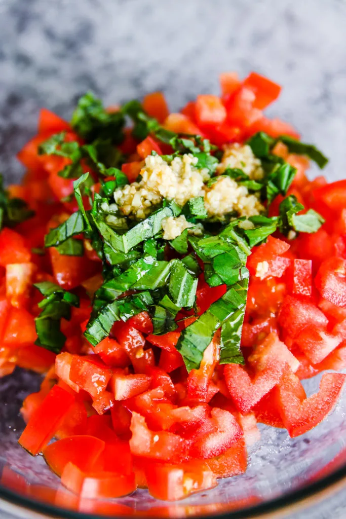 diced tomatoes with chopped basil and minced garlic on top