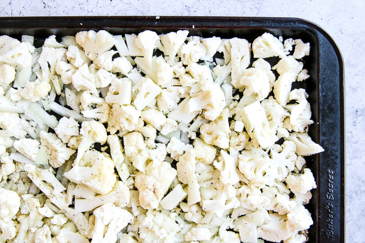 a cookie sheet of seasoned cauliflower florets