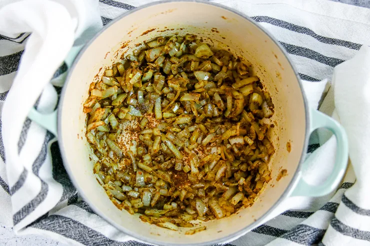 a blue pan of sauteed onions and spices