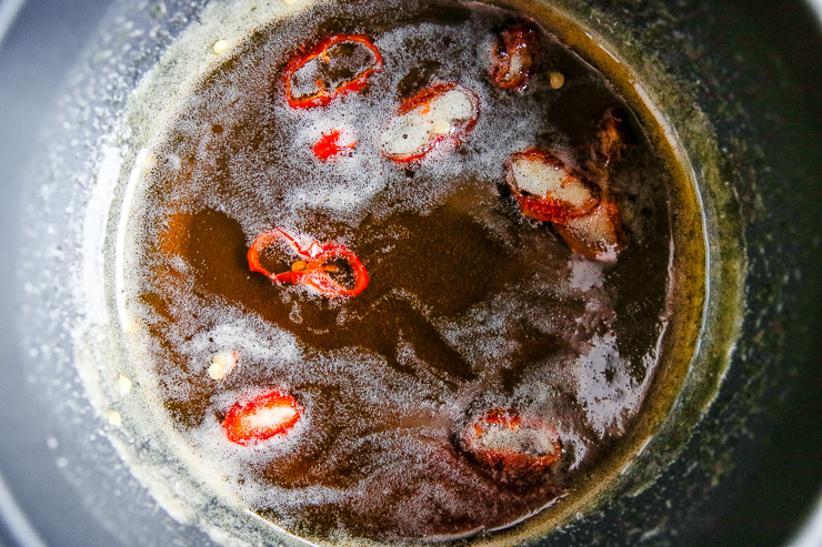 a close up of sliced pepper sizzling in honey