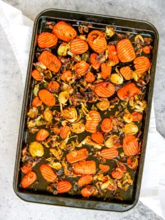 a sheet pan full of roasted brussels sprouts and carrots