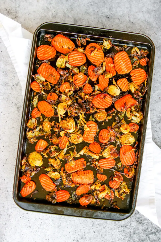 a sheet pan full of roasted brussels sprouts and carrots