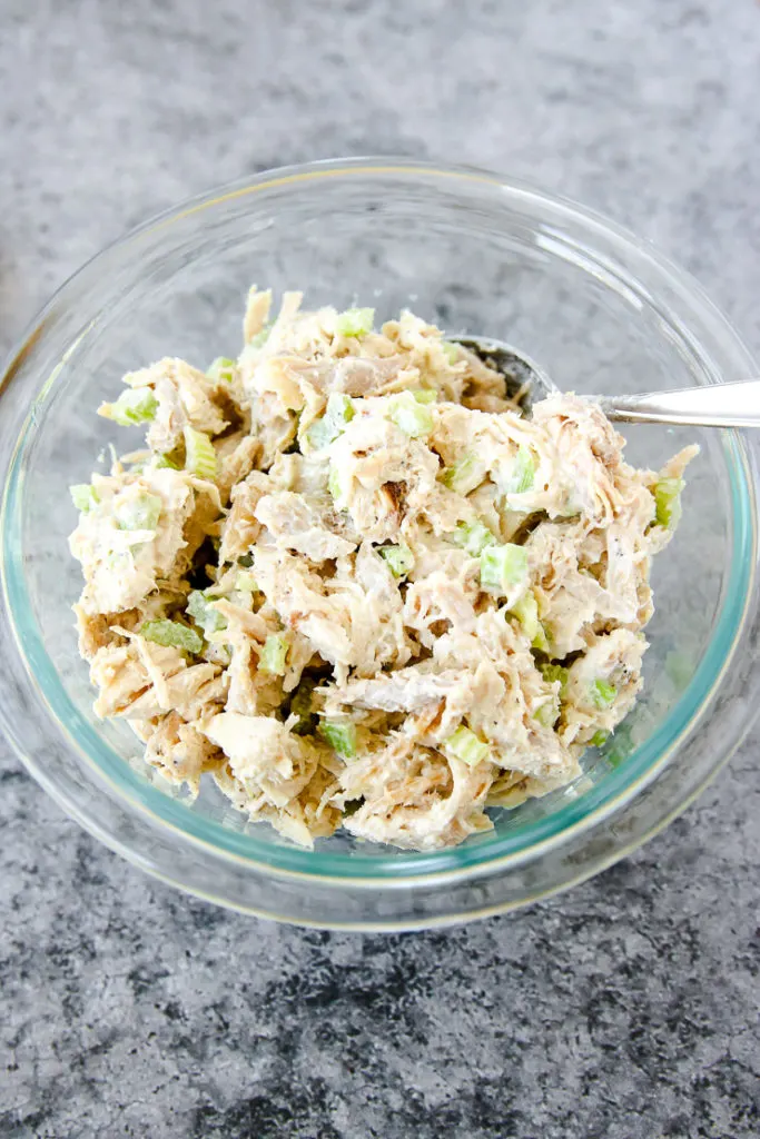 a glass bowl of rotisserie chicken salad